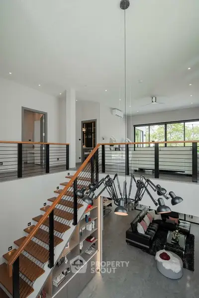Stunning modern living room with high ceilings and elegant staircase