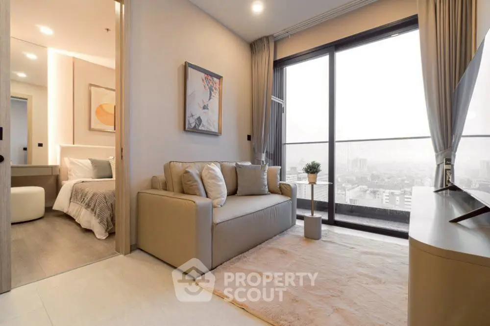 Modern living room with cozy sofa and large window offering city view