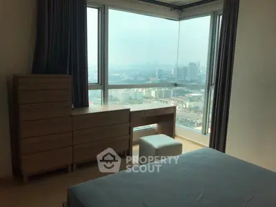 Spacious bedroom with panoramic city view and modern furnishings