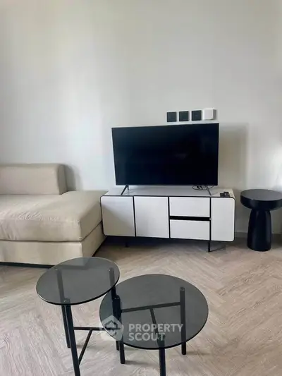 Modern living room with sleek furniture and flat-screen TV, perfect for contemporary urban living.