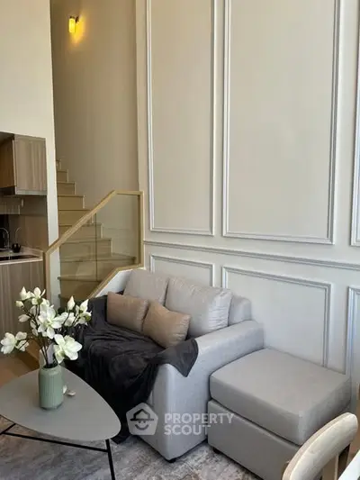 Modern living room with cozy sofa and elegant decor in a stylish apartment.