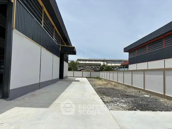Modern industrial warehouse exterior with spacious concrete yard