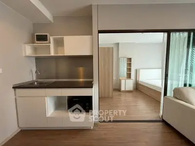 Modern studio apartment with sleek kitchen and cozy bedroom