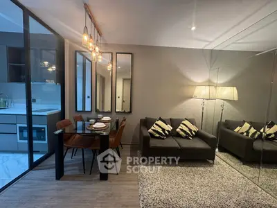 Modern living room with stylish decor and dining area in open layout apartment.