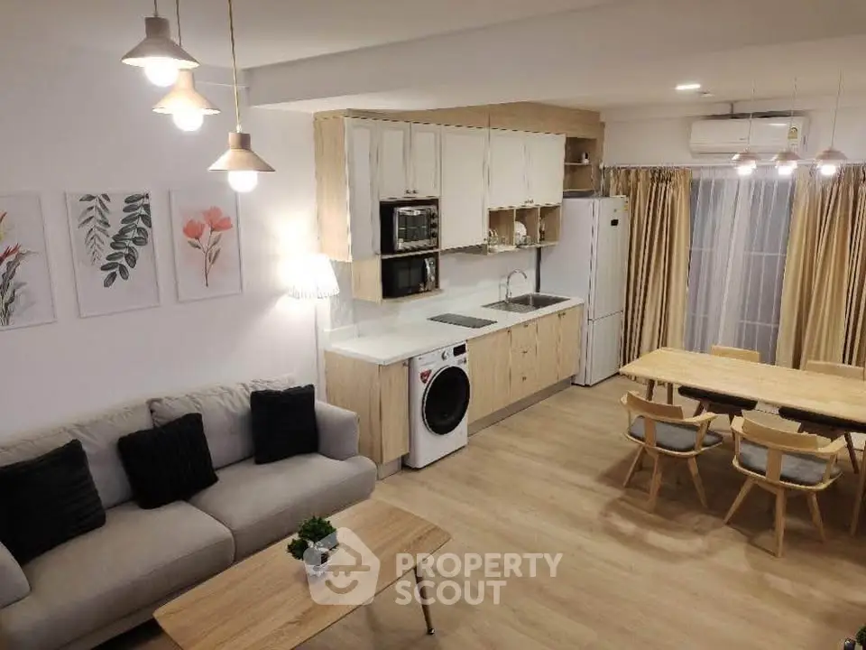 Modern open-plan living room and kitchen with stylish decor and appliances