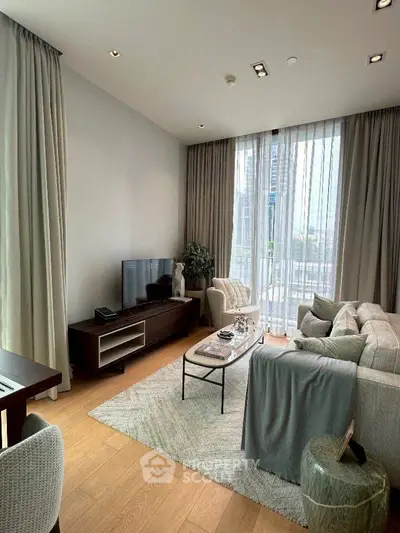 Luxurious living room with elegant decor and floor-to-ceiling windows offering stunning city views.