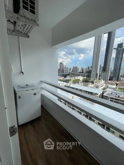 High-rise balcony with city view and washing machine, perfect for urban living.