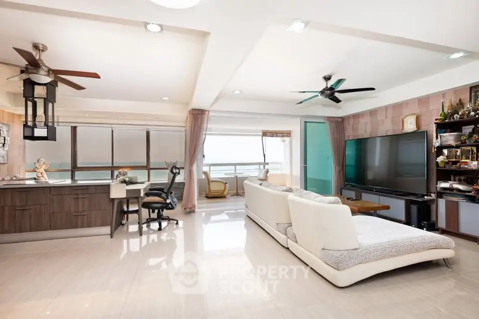 Spacious modern living room with open layout and large windows offering stunning views.