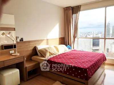 Spacious bedroom with city view in modern high-rise apartment