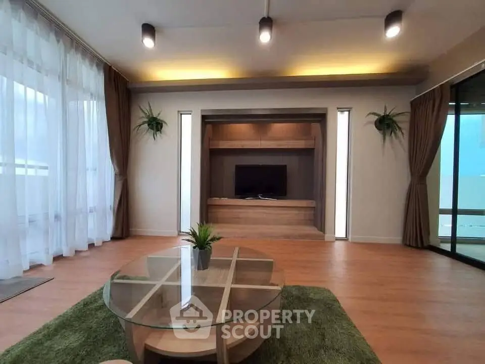 Spacious modern living room with elegant decor and large windows for natural light.