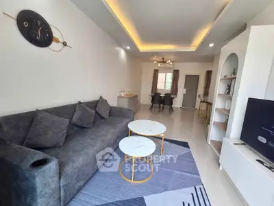 Modern living room with stylish decor and cozy seating area, perfect for relaxation and entertainment.