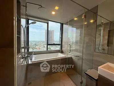 Luxurious bathroom with stunning city view and modern glass shower enclosure.