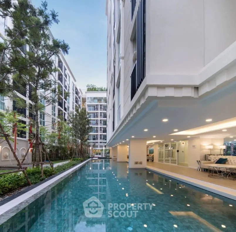 Luxurious apartment complex with stunning pool and modern architecture.