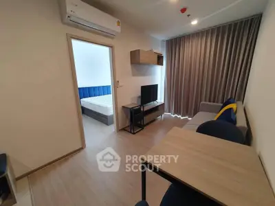 Modern living room with stylish furniture and view into a cozy bedroom, perfect for urban living.