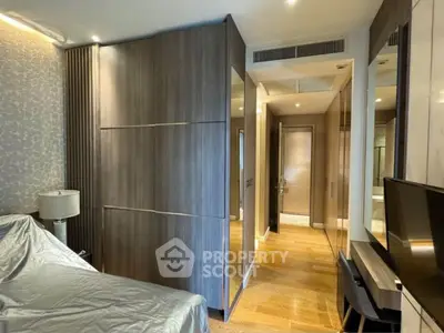 Modern bedroom with sleek wooden wardrobe and stylish decor
