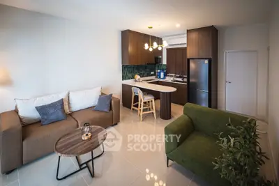 Modern open-layout living room with stylish kitchen and cozy seating area