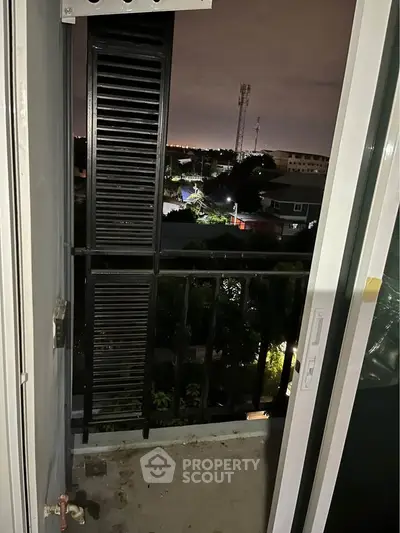 Charming balcony view overlooking cityscape at night, perfect for relaxation and enjoying the skyline.