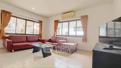 Spacious living room with modern furniture and large windows for natural light.