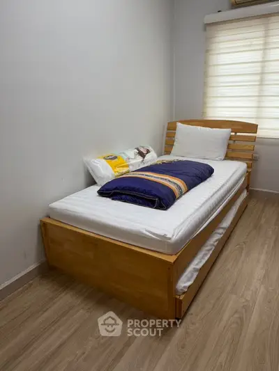 Cozy bedroom with wooden single bed and modern decor