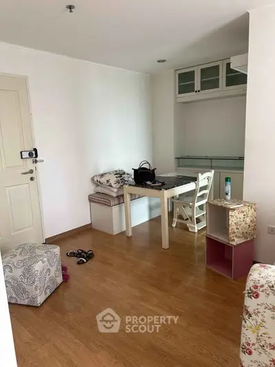 Cozy interior with wooden flooring and compact dining area in modern apartment