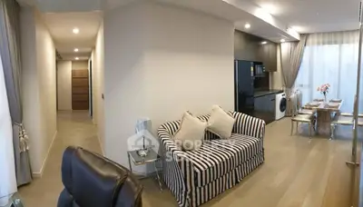 Modern living room with striped sofa, dining area, and hallway in stylish apartment.
