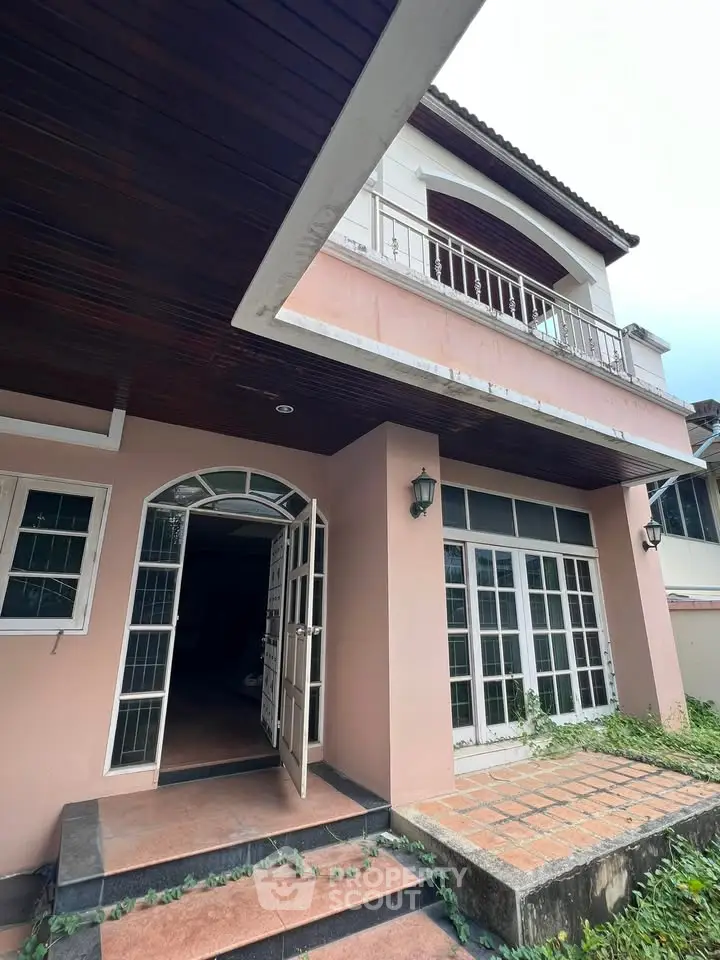 Charming two-story house with spacious balcony and elegant entrance