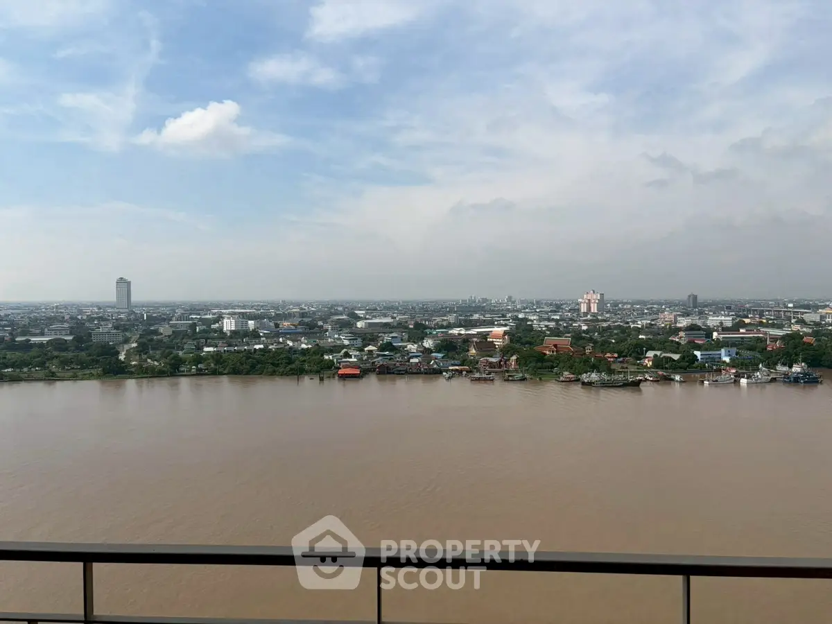 Stunning river view from high-rise balcony overlooking cityscape.