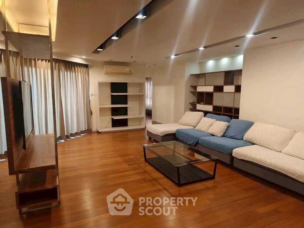 Spacious modern living room with wooden flooring and stylish furniture