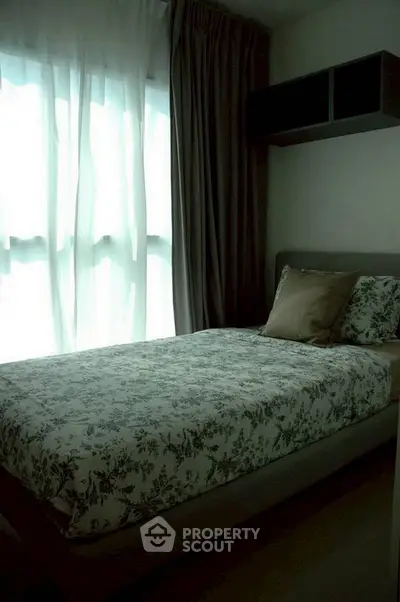 Cozy bedroom with floral bedding and soft natural light