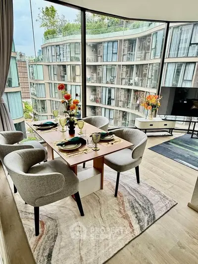 Luxurious dining area with panoramic city views and elegant decor in modern apartment.