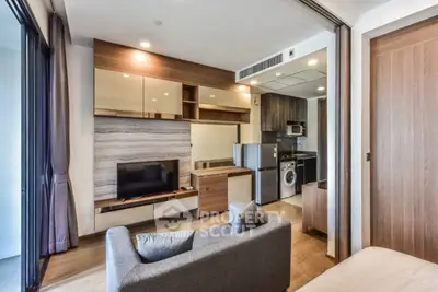 Modern living room with open kitchen and stylish decor in a cozy apartment.