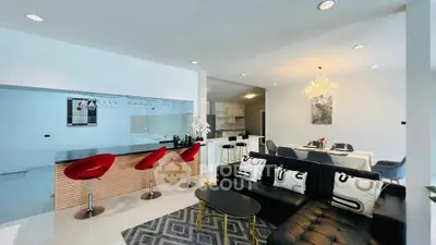 Modern open-plan living room with stylish kitchen and elegant dining area, featuring chic decor and contemporary lighting.