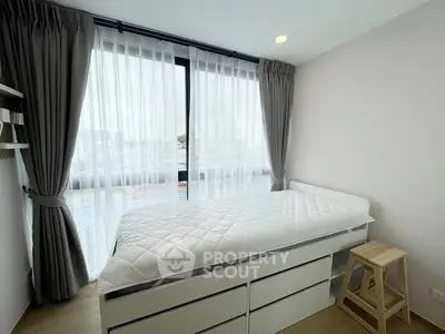 Bright bedroom with large window and modern decor in a stylish apartment.