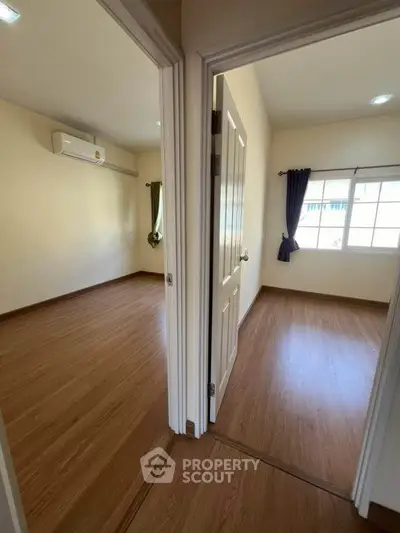 Spacious two-bedroom unit with wooden flooring and ample natural light.