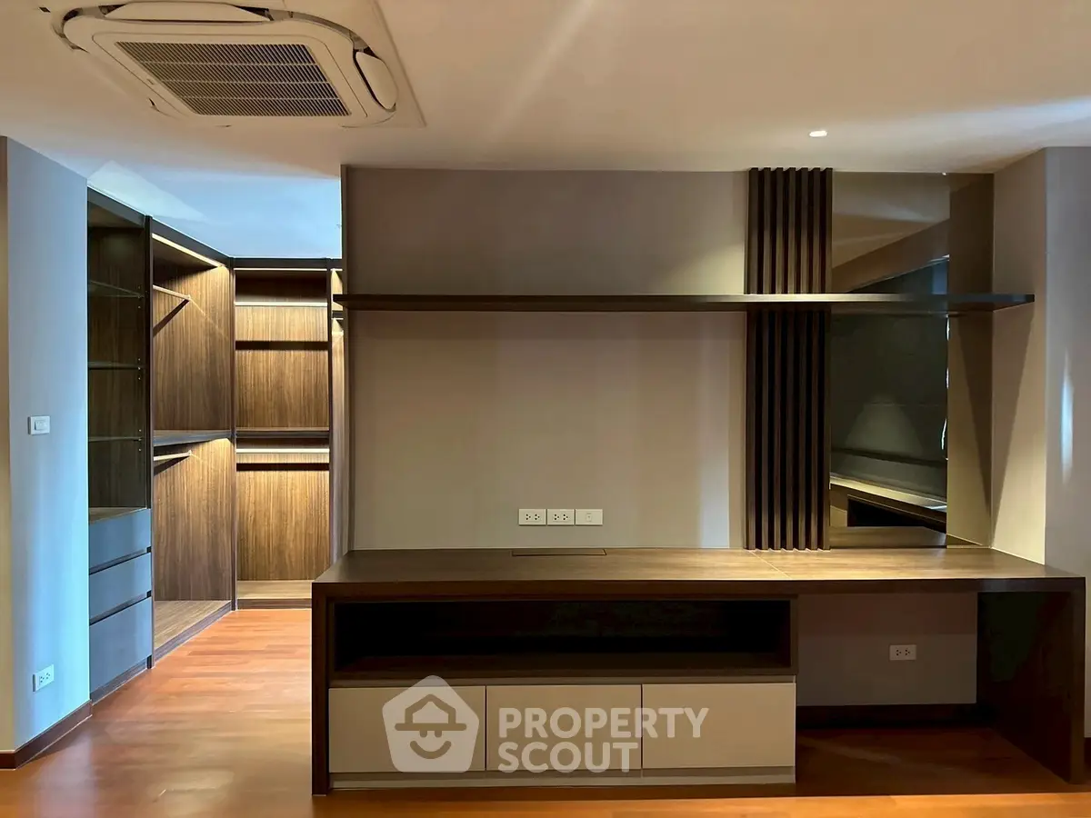 Spacious modern study room with built-in wooden shelves and desk, perfect for productivity.