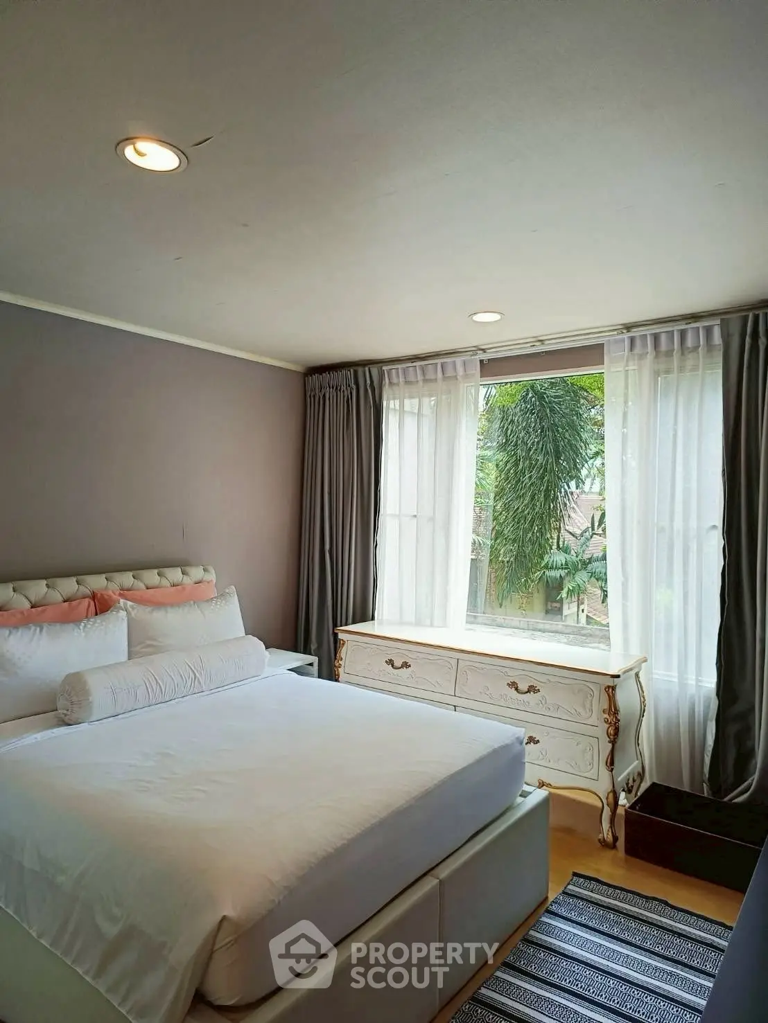Cozy bedroom with elegant decor and large window view