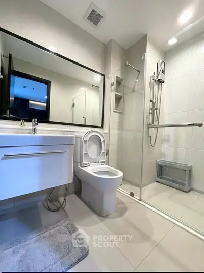 Modern bathroom with sleek fixtures and glass shower enclosure