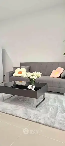 Modern living room with sleek gray sofa and stylish coffee table