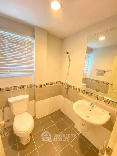 Modern bathroom with sleek design and stylish tiles in a cozy apartment.