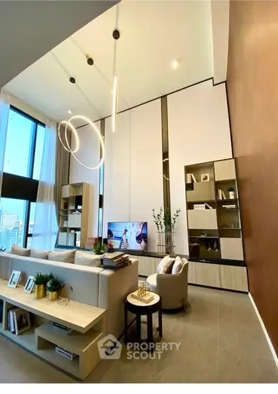 Luxurious modern living room with high ceilings and elegant lighting in a stylish apartment.