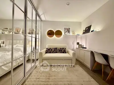 Modern bedroom with mirrored closet and cozy seating area
