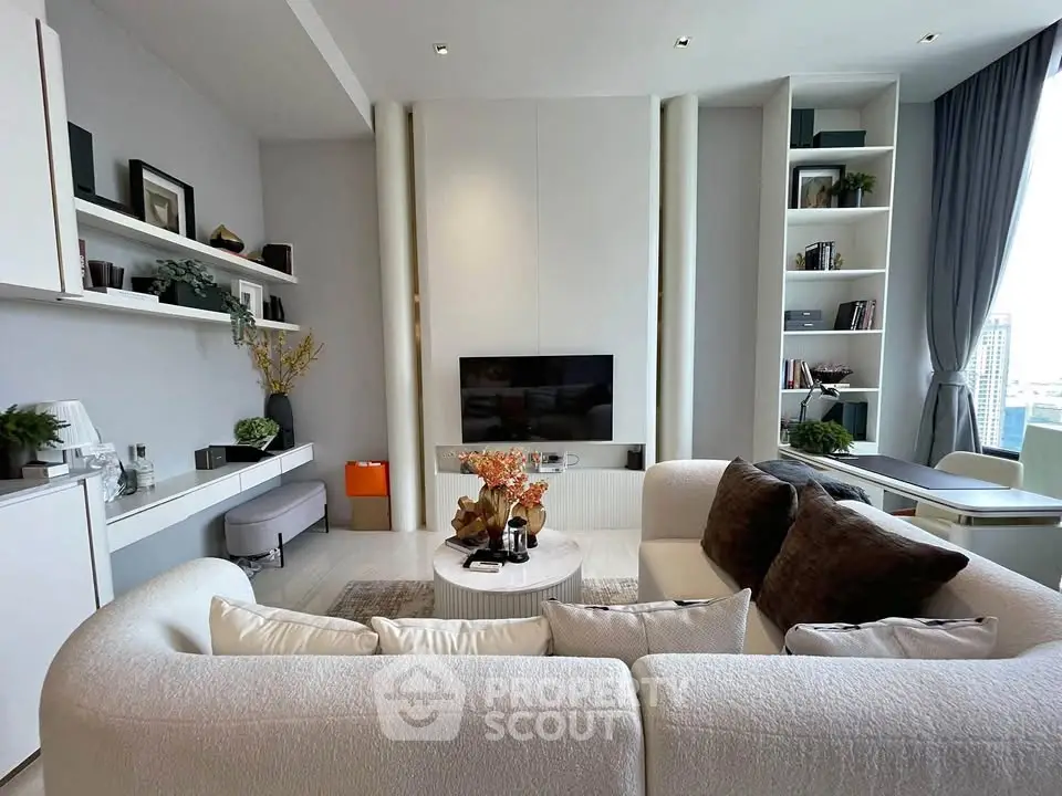 Luxurious modern living room with elegant white sofa and built-in shelves, offering a stunning city view.
