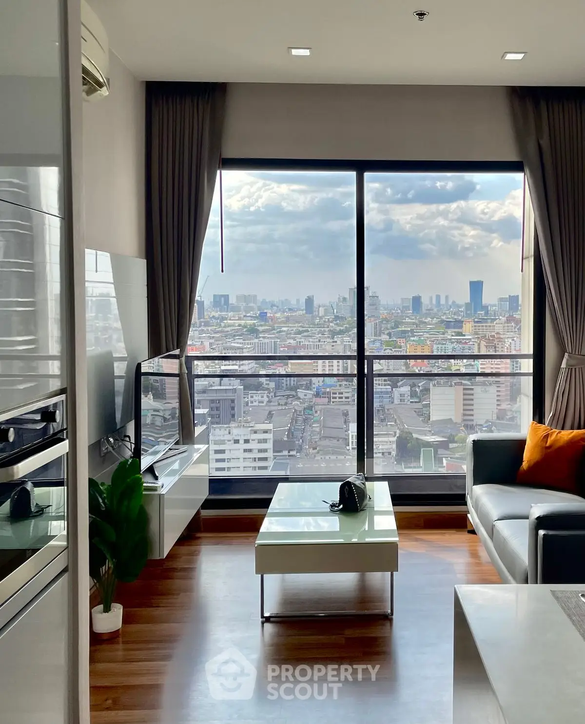 Modern living room with panoramic city view and sleek furnishings
