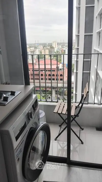 Modern balcony with washing machine and city view, perfect for urban living.