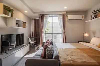 Modern studio apartment with cozy living area and natural light