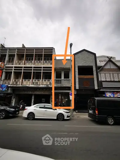 Street view of commercial buildings with potential for retail or office space in bustling urban area.
