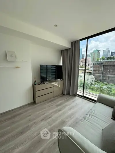 Modern living room with city view and sleek furnishings