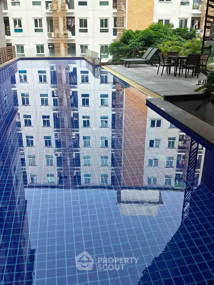 Luxurious apartment complex with a stunning outdoor pool and modern amenities.
