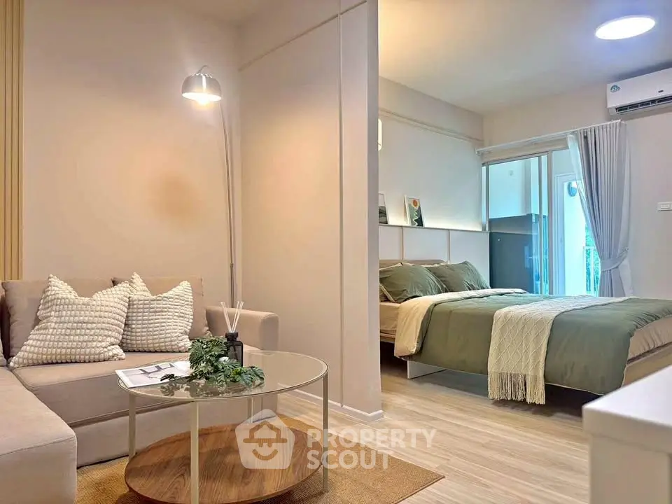 Modern studio apartment with cozy living area and stylish bedroom