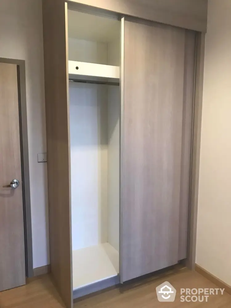 Modern built-in closet with sliding doors in a stylish apartment interior.